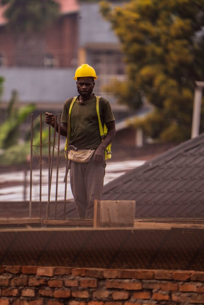 pexels photo 30674591 Construction worker in safety gear on a rooftop, focused on building work.